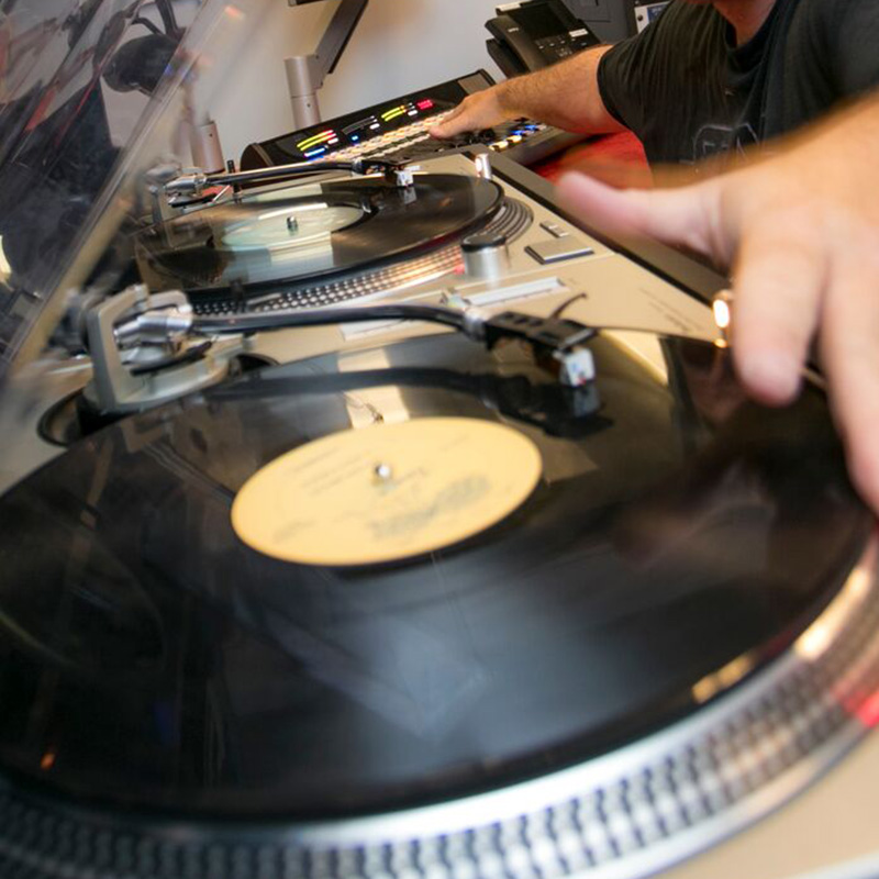 A person DJing in a recording studio.