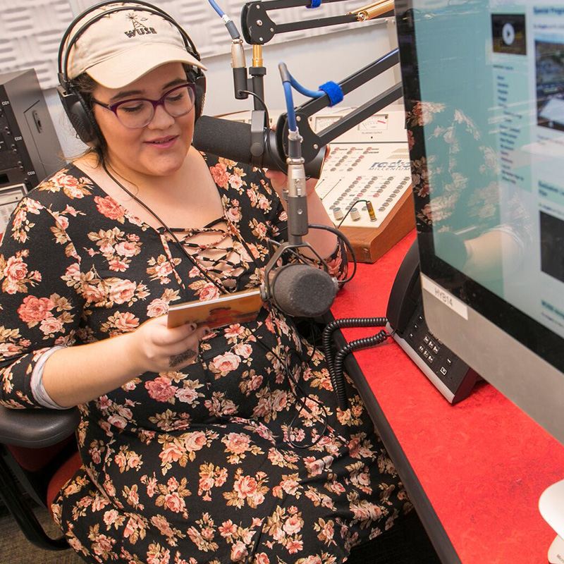 A student in a recording studio.