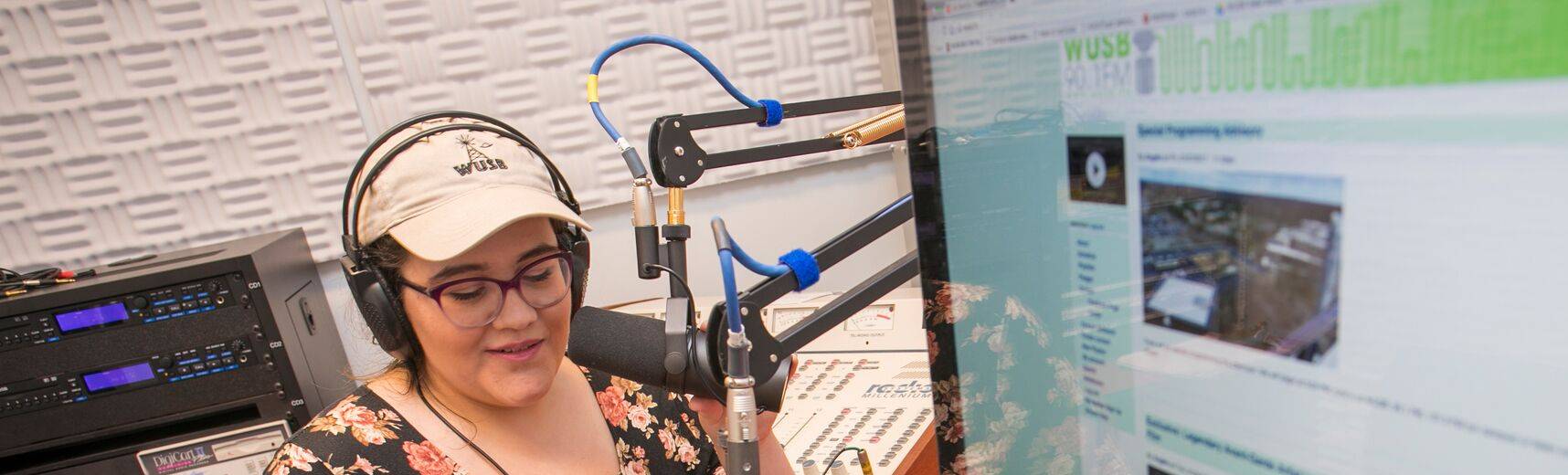 Student recording in a studio space.