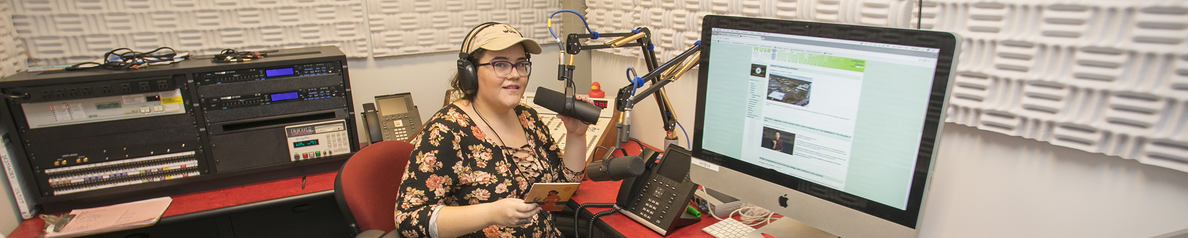 Student recording in a studio space.