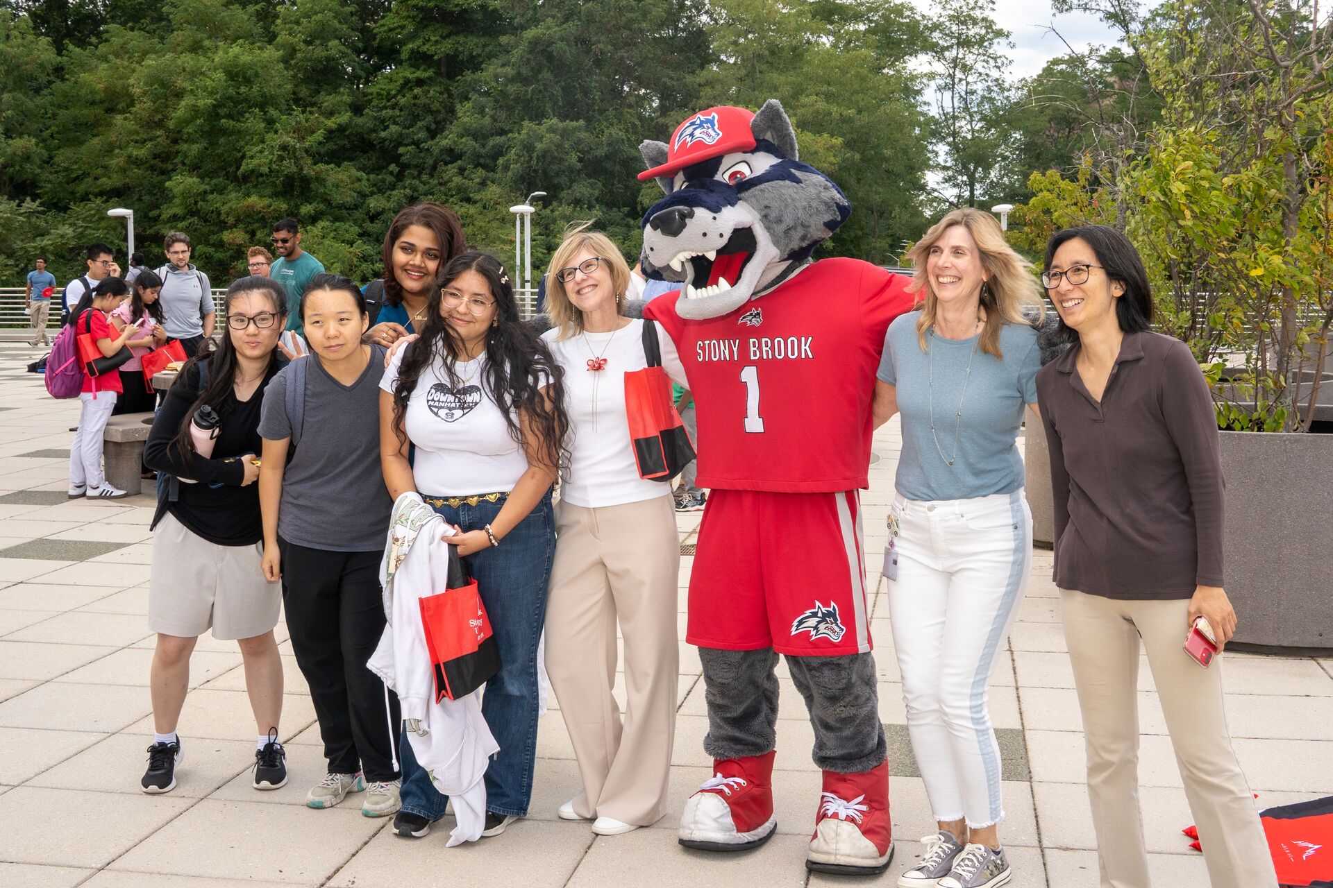gROUP OF PEOPLE SMILING WITH A FURRT MASCOT