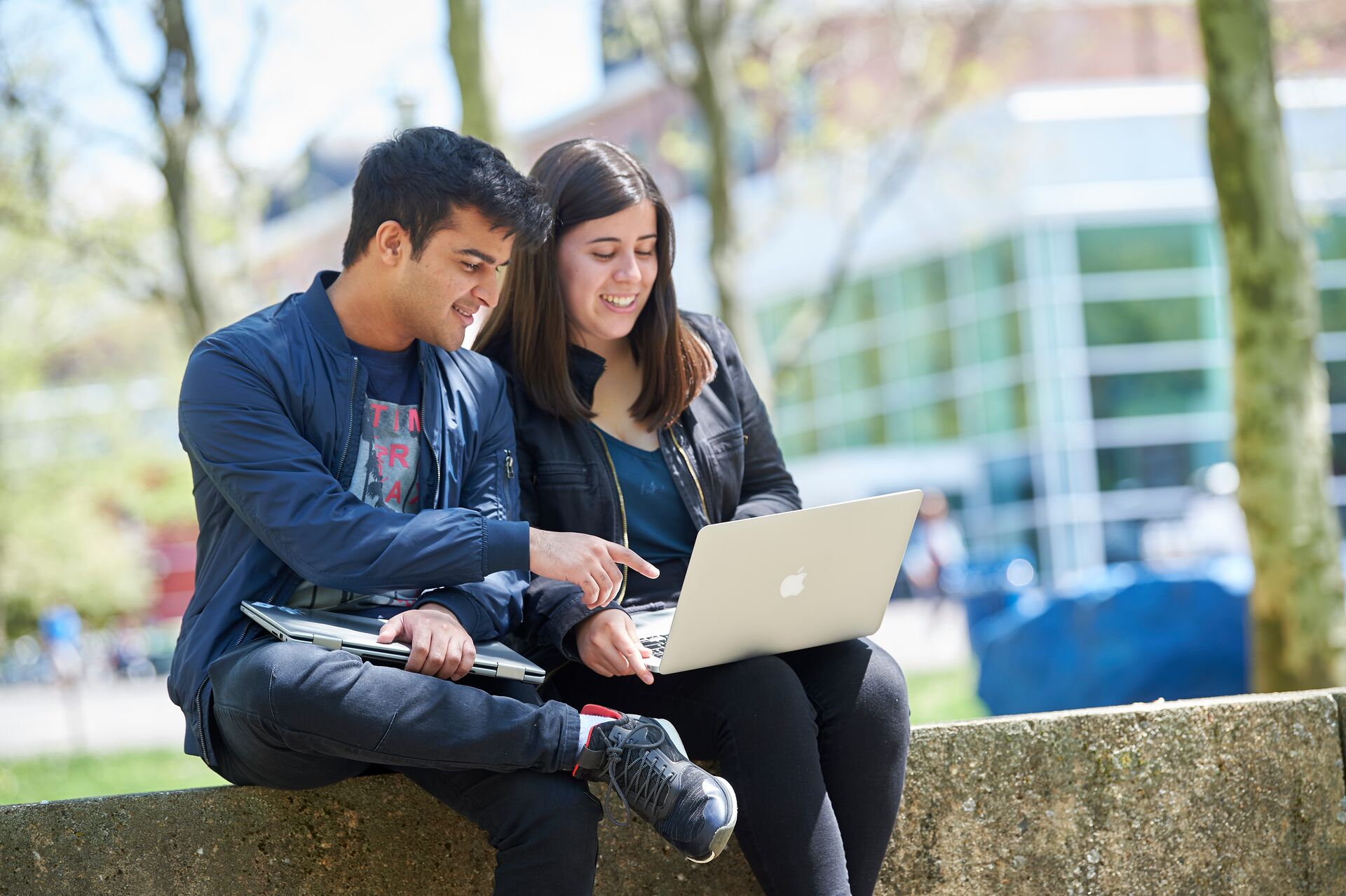 students talking with laptop