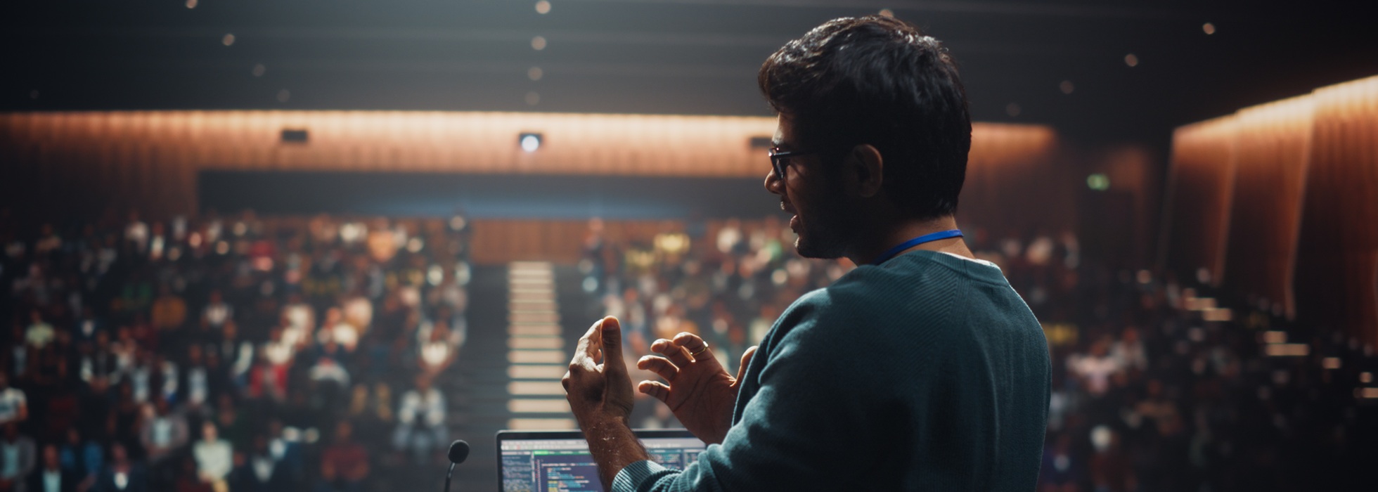Man presenting in front of large audience