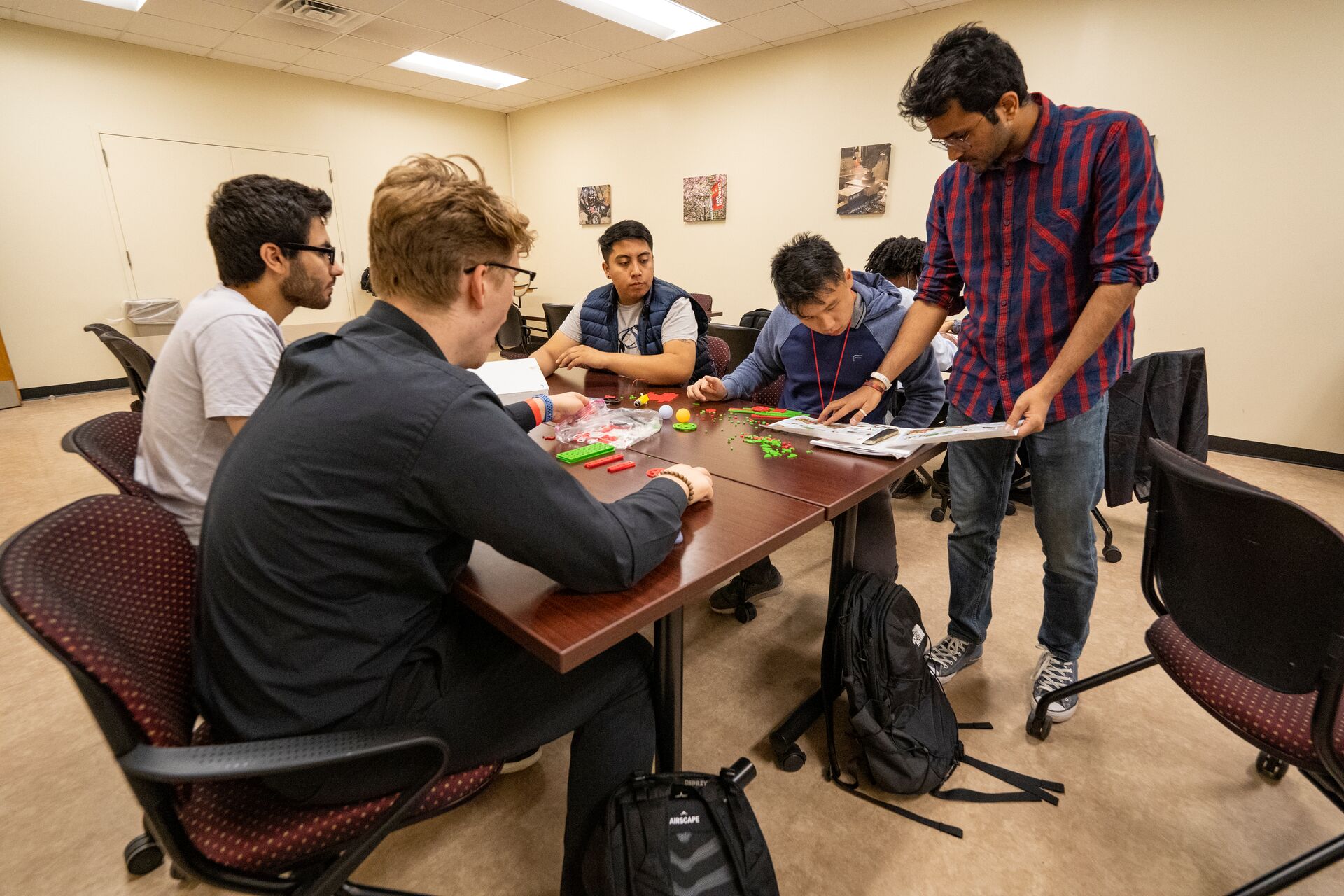 Students sitting at a table working on a project.