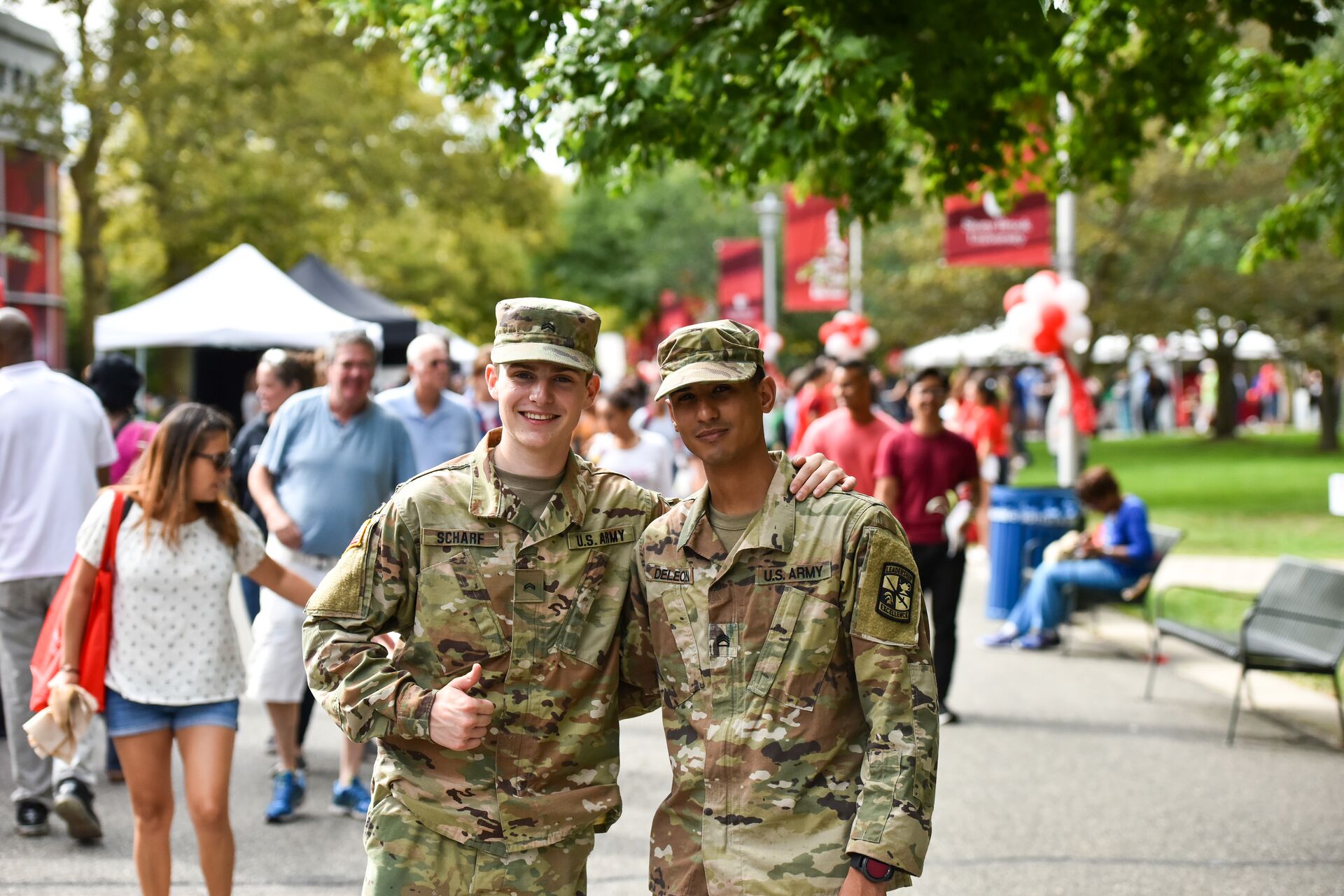 two Army ROTC students stand outside of the Student Activities Center