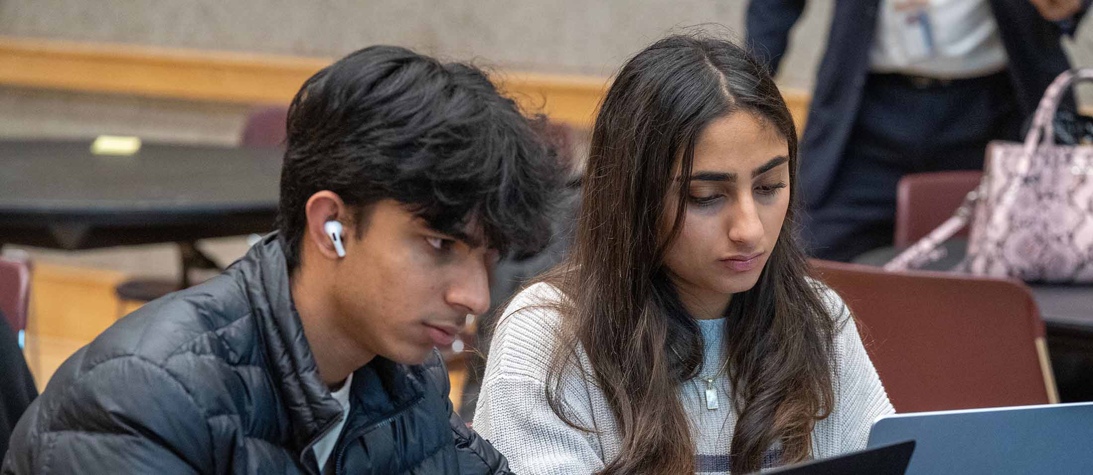 Two students looking at a laptop